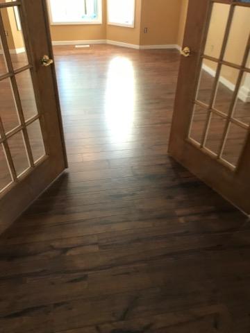 A room with hardwood floors and a doorway.