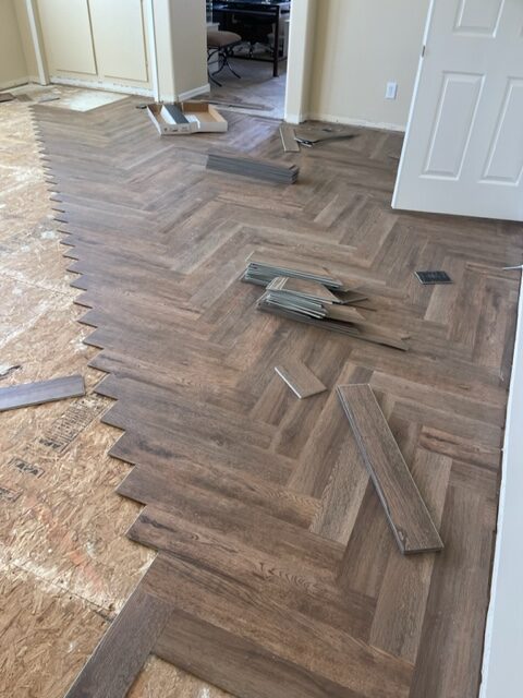 A room with wood flooring being installed.