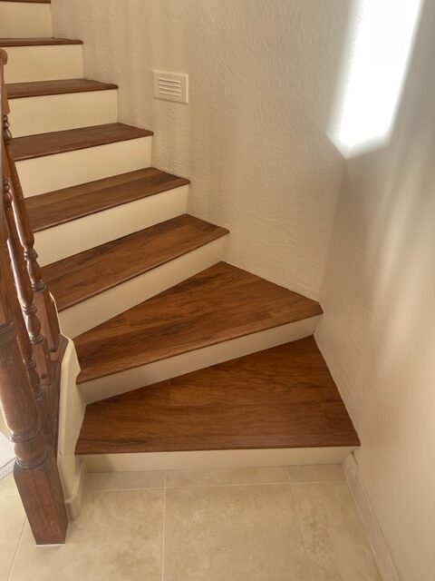 A staircase with wood treads and a wooden railing.