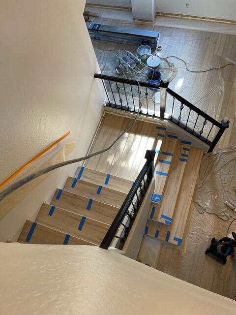 A staircase is being refinished in a home.